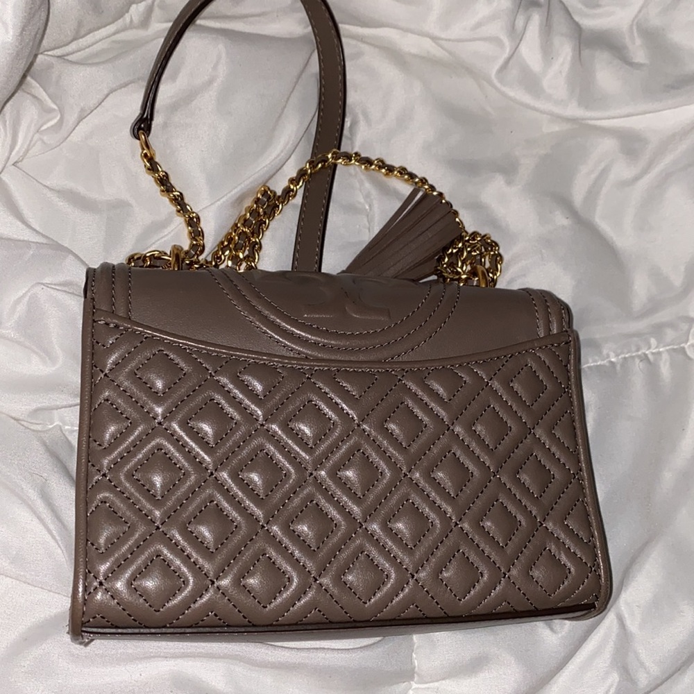 Lights worn Gray Tory Burch crossbody that can be turned into shoulder bag.